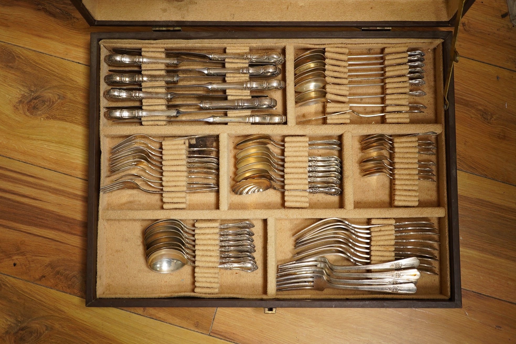 A cased part canteen of American sterling cutlery, weighable silver 63.8oz, together with four silver plated table forks. Condition - poor to fair